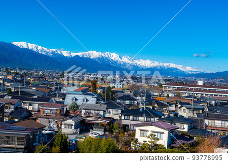 The city of Azumino in early winter with fine weather and the Northern Alps covered with snow [Nagano Prefecture] 93778995