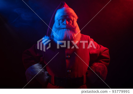 Santa Claus portrait in blue red neon light and smoke. Santa Claus portrait in blue red neon light and smoke. 93779991