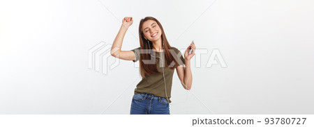 Portrait of a cheerful cute woman listening music in headphones and dancing isolated on a white background. Portrait of a cheerful cute woman listening music in headphones and dancing isolated on a white background. 93780727
