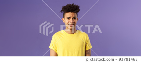 Close-up portrait of awkward and embarrassed young hispanic guy looking nervous, meeting girlfriend parents, stare scared and with panic, feeling concerned, cringe over purple background Close-up portrait of awkward and embarrassed young hispanic guy looking nervous, meeting girlfriend parents, stare scared and with panic, feeling concerned, cringe over purple background 93781465