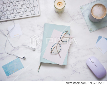 A workspace image of arranging small items in refreshing colors on a marble desk 93781546