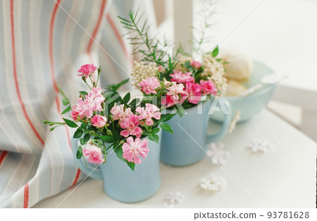 Astragalus flowers arranged in a blue antique mug Astragalus flowers arranged in a blue antique mug 93781628