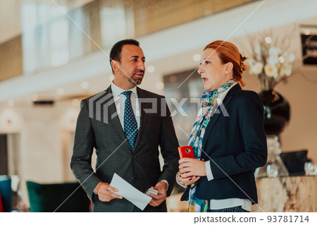 Photo of a businessman and businesswoman discussing business projects in a modern corporation. Selective focus  93781714