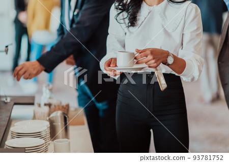 Close-up photo of businesswoman serving themselves in a modern hotel during a dinner party. Selective focus Close-up photo of businesswoman serving themselves in a modern hotel during a dinner party. Selective focus 93781752