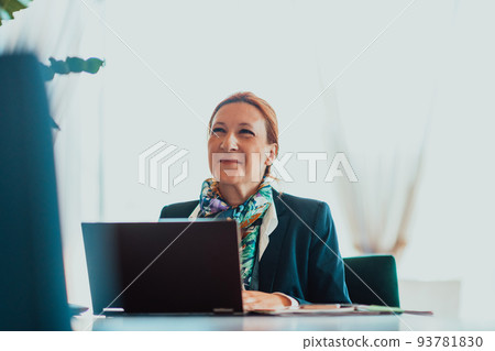 Photo of an elderly woman using a laptop to carry out business projects and tasks while sitting in a modern corporation Photo of an elderly woman using a laptop to carry out business projects and tasks while sitting in a modern corporation 93781830