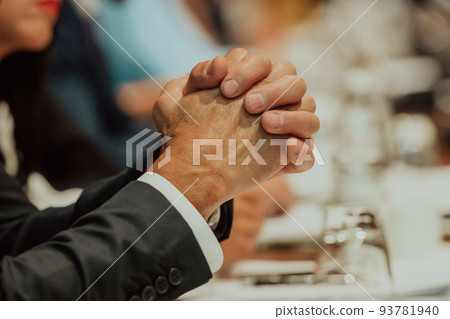 Close-up photo of businessmen who are at a meeting and business meeting in a modern hall Close-up photo of businessmen who are at a meeting and business meeting in a modern hall 93781940