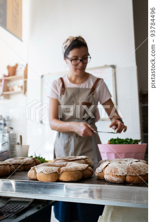 Finished French bread in the bakery on the table. Rustic bread, the crown of the Bordeaux kings. Front view. 93784496