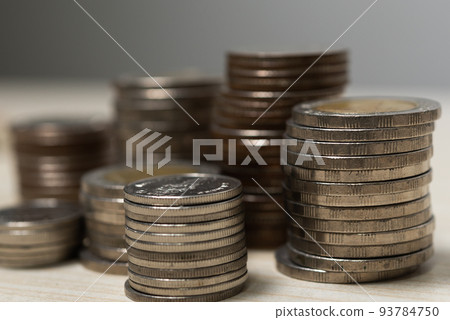 Saving money coin stack on table.Business investment currency economy finance and banking concept. Saving money coin stack on table.Business investment currency economy finance and banking concept. 93784750