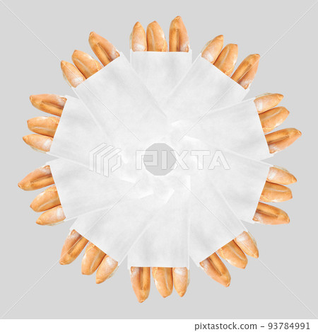 A French loaf in a white paper bag insulated on a white background. White bread in a craft bag. Geometric circular pattern of bread in a bag. 93784991