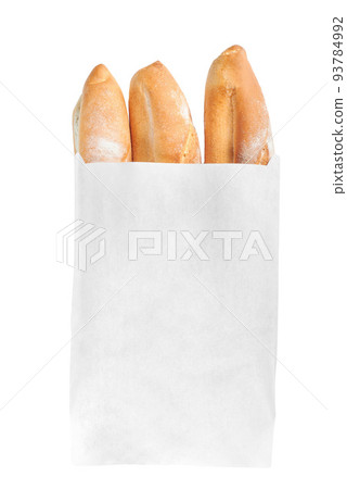 A French loaf in a white paper bag insulated on a white background. White bread in a craft bag. A paper bag full of bread. 93784992