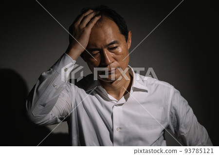 A man in his 50s thinking, a businessman with stress 93785121