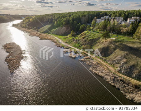 Aerial view of river shore with rocks and forest. Spring or autumn season. Iset River, Ural mountains, Russia. 93785334