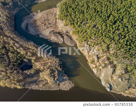 Aerial view of river shore with rocks and forest. Spring or autumn season. Iset River, Ural mountains, Russia. 93785338