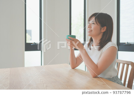 Young woman relaxing in the living room Young woman relaxing in the living room 93787796