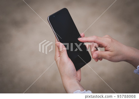 Hands of a woman operating a smartphone Hands of a woman operating a smartphone 93788008