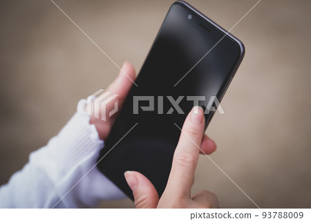 Hands of a woman operating a smartphone 93788009