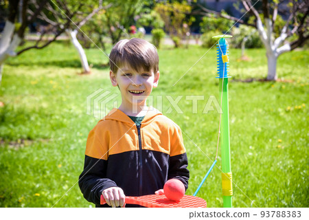 Happy boy is playing tetherball swing ball game in summer campin Happy boy is playing tetherball swing ball game in summer campin 93788383