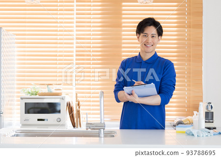 House cleaning man inspecting the kitchen 93788695