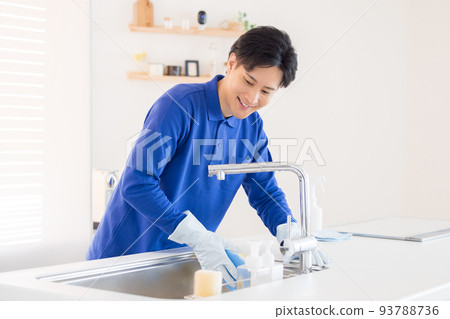 House cleaning A man cleaning the kitchen 93788736