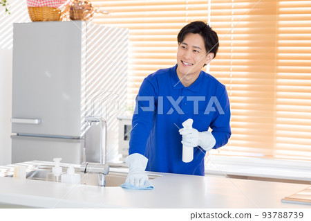 House cleaning A man cleaning the kitchen House cleaning A man cleaning the kitchen 93788739