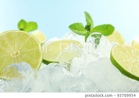 Ice with mint and lime on blue background Ice with mint and lime on blue background 93789954