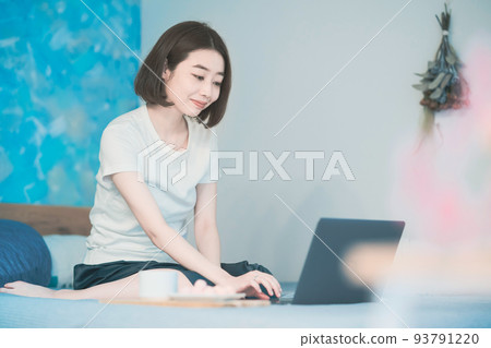 A woman looking at a stay home computer screen 93791220