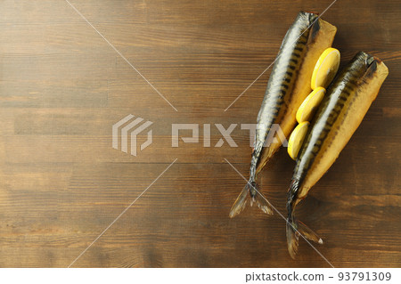 Concept of tasty food with smoked mackerel on wooden table Concept of tasty food with smoked mackerel on wooden table 93791309