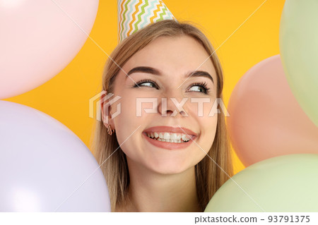 Concept of Happy Birthday, young woman on yellow background 93791375