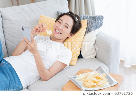 Middle-aged women lazing around at home Middle-aged women lazing around at home 93791726
