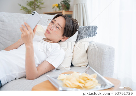 Middle-aged women lazing around at home 93791729