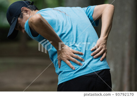 Middle male runner with back pain 93792170