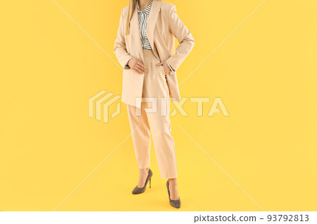 Concept of business with young attractive business woman on yellow background 93792813