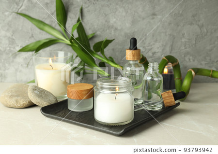 Concept of relaxation with aroma candles on light textured table Concept of relaxation with aroma candles on light textured table 93793942