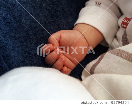 sleeping baby's hand with palm up 93794294