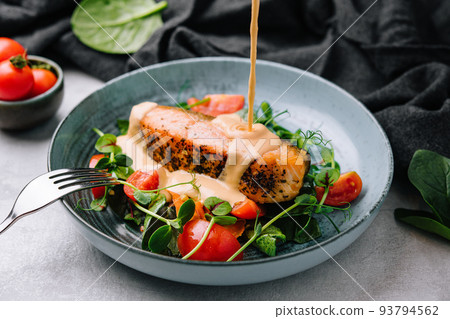 Grilled salmon with vegetables and sour cream sauce 93794562