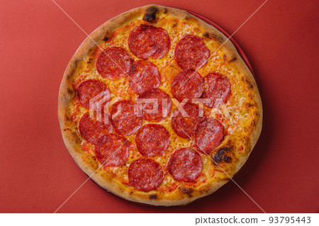 Fresh tasty pizza with pepperoni on red background 93795443