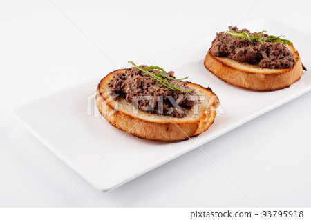 delicious italian bruschetta with truffle pate on white plate 93795918