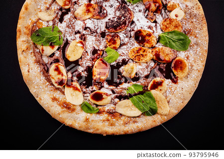 Tasty hot italian pizza for children with banana, chocolate and coconut 93795946