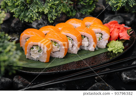 Salmon sushi with rice on black plate Salmon sushi with rice on black plate 93796382
