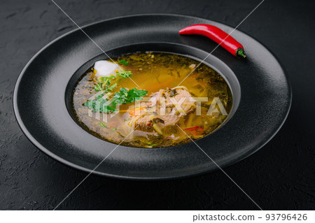 Chicken noodle soup in black plate 93796426