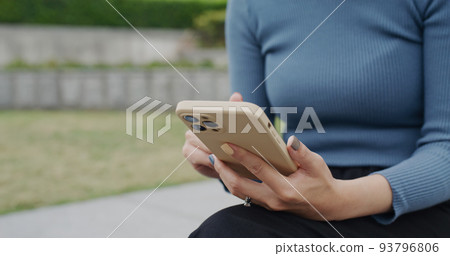 Woman use of mobile phone at outdoor 93796806