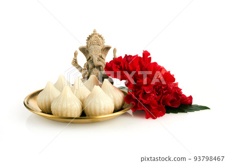 Idol of lord Ganesha with Modak Sweet Dish and flower. Ganesh chaturthi 93798467