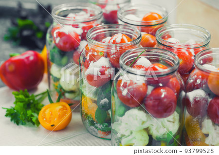 The process of preserving cucumbers and tomatoes for the winter. The process of preserving cucumbers and tomatoes for the winter. 93799528