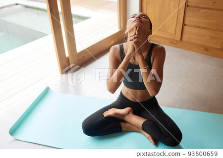 Girl Practices Yoga Exercising At Home. Beautiful Woman Meditating Girl Practices Yoga Exercising At Home. Beautiful Woman Meditating 93800659