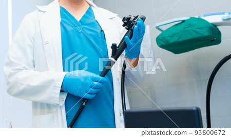 Selective focus on doctor's hands holding an endoscope.  93800672
