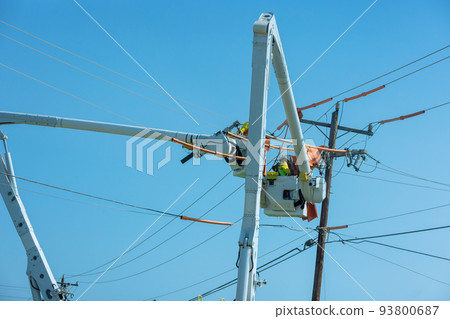 It is a job for the electrician worker to repair the damaged power lines caused by the storm in the electric power pole maintenance industry. It is a job for the electrician worker to repair the damaged power lines caused by the storm in the electric power pole maintenance industry. 93800687
