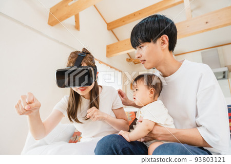 Family wearing VR goggles in the living room Family wearing VR goggles in the living room 93803121