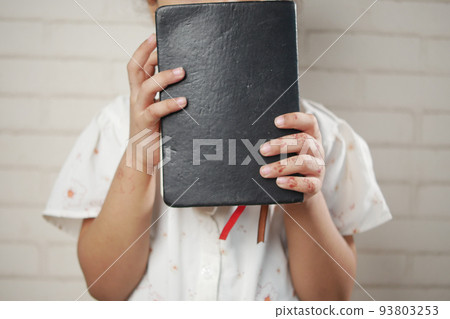 child girl holding many colorful notepad sited on chair child girl holding many colorful notepad sited on chair 93803253