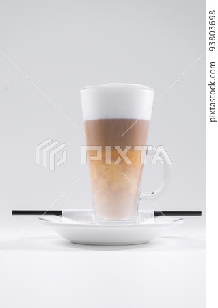 tasty italian latte coffee with straw and saucer isolated on white background 93803698