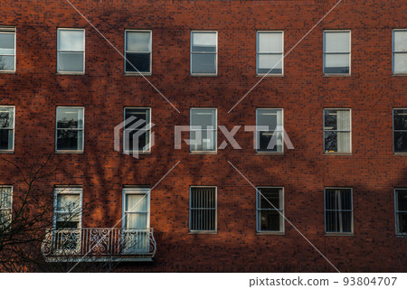 The facade of the old house. The Windows and decoration of walls. 93804707